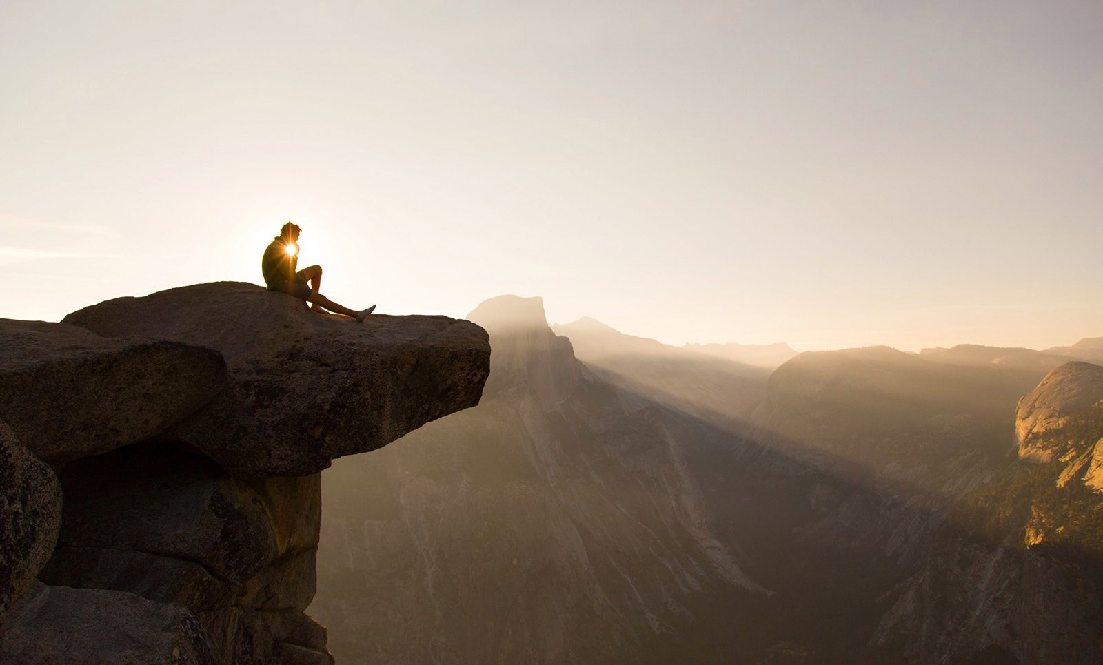 A person sitting on top of a rock in Yosemite